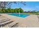 Outdoor community pool with lounge chairs and greenery surrounded by a fence in the neighborhood at 14052 Rayners Ln, Fishers, IN 46037