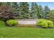 Stone sign for Avalon of Fishers community featuring manicured landscaping with trees and bushes at 14052 Rayners Ln, Fishers, IN 46037