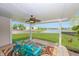 Relaxing covered patio with colorful decor, comfortable seating, and a serene view of the backyard and scenic pond at 14052 Rayners Ln, Fishers, IN 46037