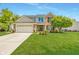 Charming two-story brick home with a well-manicured front yard and two car garage at 14052 Rayners Ln, Fishers, IN 46037