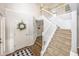 Grand foyer with a staircase, hardwood floors, and elegant decor creating a welcoming entrance at 14052 Rayners Ln, Fishers, IN 46037