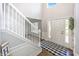 Bright foyer featuring a staircase, hardwood floors, and natural light streaming through the front door windows at 14052 Rayners Ln, Fishers, IN 46037