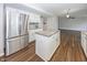 Kitchen featuring stainless steel refrigerator, white cabinets, granite countertops and a center island at 14052 Rayners Ln, Fishers, IN 46037