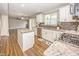 Kitchen with center island, granite counters, modern backsplash and stainless steel appliances at 14052 Rayners Ln, Fishers, IN 46037