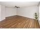 Open living room featuring a ceiling fan, neutral paint and wood-look flooring at 14052 Rayners Ln, Fishers, IN 46037