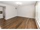 The large living room has wood-look floors, neutral walls, and modern light fixture at 14052 Rayners Ln, Fishers, IN 46037