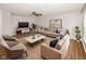 Staged living room featuring modern furnishings, a ceiling fan and wood-look flooring at 14052 Rayners Ln, Fishers, IN 46037