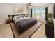 Comfortable main bedroom features a ceiling fan, large windows, and neutral walls at 14052 Rayners Ln, Fishers, IN 46037
