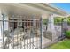 Outdoor seating area under a covered patio surrounded by a fence and greenery at 14052 Rayners Ln, Fishers, IN 46037