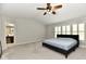 Spacious bedroom features a ceiling fan, ample natural light, and neutral decor at 14082 Brazos Dr, Carmel, IN 46033