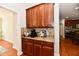 Butler's pantry with granite countertops and dark wood cabinets at 14082 Brazos Dr, Carmel, IN 46033