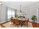 Formal dining room with hardwood floors, neutral paint, and ample seating for six at 14082 Brazos Dr, Carmel, IN 46033