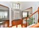 Grand foyer with soaring ceilings, hardwood floors, staircase and elegant light fixture creating a welcoming ambiance at 14082 Brazos Dr, Carmel, IN 46033