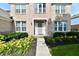 Close up of a well-maintained home featuring manicured landscaping and an inviting front entrance with a gray front door at 14082 Brazos Dr, Carmel, IN 46033