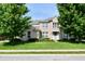 Inviting two-story home with lush green lawn, mature trees, and blooming flowerbeds enhancing its curb appeal at 14082 Brazos Dr, Carmel, IN 46033