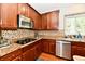 Spacious kitchen features stainless steel appliances, granite countertops, and tile backsplash at 14082 Brazos Dr, Carmel, IN 46033