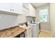 Bright laundry room features washer, dryer, sink, storage cabinets and large window at 14082 Brazos Dr, Carmel, IN 46033
