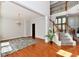Inviting living room with hardwood floors, staircase, and charming chandelier lighting at 14082 Brazos Dr, Carmel, IN 46033