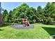 Backyard features a playset, privacy fence, and mature trees for a Gathering-friendly and relaxing outdoor space at 14082 Brazos Dr, Carmel, IN 46033