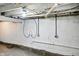 Basement with painted walls and plumbing, offering a clean and utilitarian space ready for customization at 1430 W 14Th St, Anderson, IN 46016