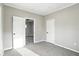 This bedroom is light and neutral with a ceiling fan visible from open doorway at 1430 W 14Th St, Anderson, IN 46016