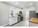 A bright, updated kitchen features white cabinets, stainless appliances, and wood countertops at 1430 W 14Th St, Anderson, IN 46016