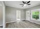 Living room featuring neutral walls, wood floors, ceiling fan, and views to other rooms at 1430 W 14Th St, Anderson, IN 46016