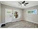 Living room featuring neutral walls, wood floors, ceiling fan, and views to other rooms at 1430 W 14Th St, Anderson, IN 46016
