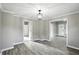 A lovely open-concept living room features wood floors and a hanging light fixture at 1430 W 14Th St, Anderson, IN 46016