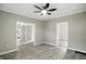 Living room featuring neutral walls, wood floors, ceiling fan, and views to other rooms at 1430 W 14Th St, Anderson, IN 46016