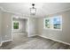 View of a sunny living room with wood flooring, and hanging light fixture at 1430 W 14Th St, Anderson, IN 46016