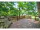 A wooden back deck featuring a bench swing, fence, and a view of the landscaped yard at 1456 Bent Tree Pl, Greenwood, IN 46143