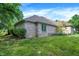 Backyard featuring a brick house, green grass, mature trees, and lush landscaping at 1456 Bent Tree Pl, Greenwood, IN 46143