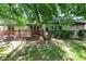 Brick home featuring a wooden deck and views of a lush backyard with mature trees at 1456 Bent Tree Pl, Greenwood, IN 46143