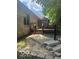 Exterior view of the home's backyard featuring a raised deck, access stairs, and mature trees at 1456 Bent Tree Pl, Greenwood, IN 46143