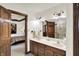 Bathroom featuring a double sink vanity with wood cabinets and a large mirror at 1456 Bent Tree Pl, Greenwood, IN 46143