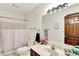 Bright bathroom featuring a marble countertop vanity, shower, and wood door at 1456 Bent Tree Pl, Greenwood, IN 46143