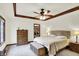 Main bedroom with tray ceiling, walk-in closet, a ceiling fan, and neutral decor at 1456 Bent Tree Pl, Greenwood, IN 46143