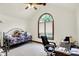 Bedroom featuring a vaulted ceiling, large arched window, ceiling fan, and day bed at 1456 Bent Tree Pl, Greenwood, IN 46143