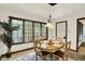 Cozy dining area boasts tiled floors, a dark window frame, and a charming chandelier above the wooden table at 1456 Bent Tree Pl, Greenwood, IN 46143