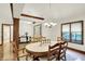 Elegant dining room featuring hardwood floors, wood trim, and ample natural light from the window at 1456 Bent Tree Pl, Greenwood, IN 46143