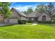 Charming brick home featuring a manicured lawn, mature trees, and an attached two-car garage at 1456 Bent Tree Pl, Greenwood, IN 46143