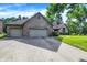 A single-story brick home with a three-car garage, a well-kept lawn, and a paved driveway at 1456 Bent Tree Pl, Greenwood, IN 46143