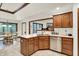 Well-lit kitchen with tile floors, a stainless steel dishwasher, and wooden cabinetry at 1456 Bent Tree Pl, Greenwood, IN 46143