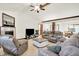 Bright living room with plush seating, a fireplace, and open access to the dining area for easy entertaining at 1456 Bent Tree Pl, Greenwood, IN 46143