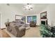 Comfortable living room with plush seating, a fireplace, and ample natural light streaming through the windows at 1456 Bent Tree Pl, Greenwood, IN 46143