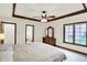 Bright main bedroom featuring tray ceilings, with a window overlooking the backyard at 1456 Bent Tree Pl, Greenwood, IN 46143