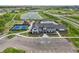 Aerial view of a community clubhouse, pool, and playground area surrounded by green spaces and residential homes at 1563 Adios Butler Ct, Danville, IN 46122