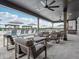 A covered patio features stylish seating, ceiling fans, and views of the pool area for a relaxing outdoor experience at 1563 Adios Butler Ct, Danville, IN 46122