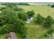 Overhead view of a house with lush greenery and surrounding farmland, offering a serene setting at 16000 W 700 S, Anderson, IN 46017